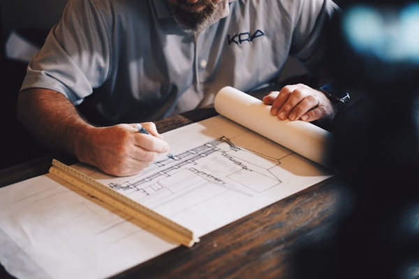Professional architect reviewing building plans with clients