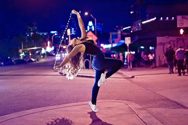 Professional dance instructor teaching a student in a modern dance studio