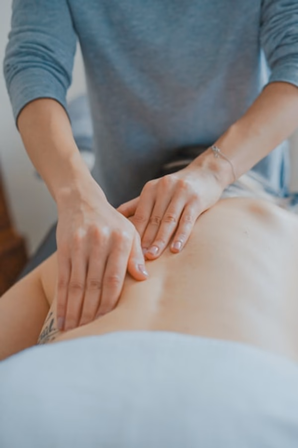 Professional massage therapist in a serene treatment room