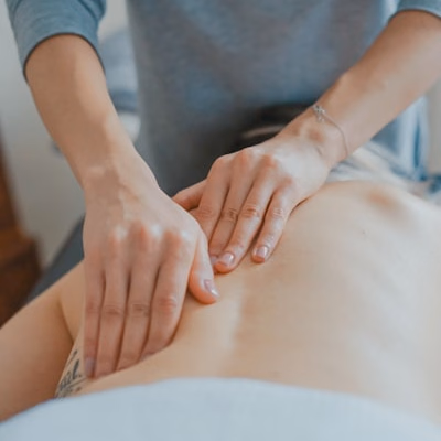 Professional massage therapist in a serene treatment room
