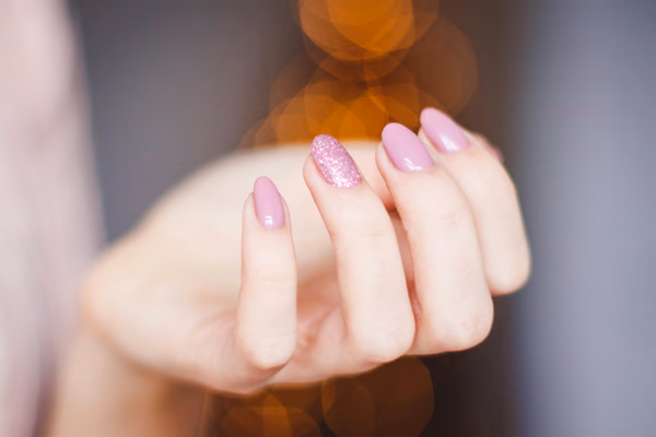 Professional nail technician performing a manicure in a modern salon