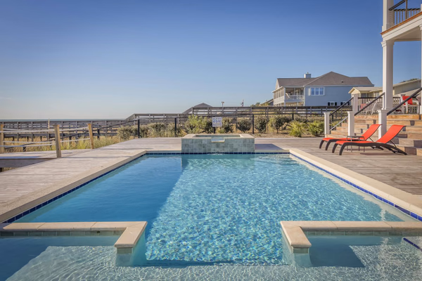Professional pool technician servicing a residential pool