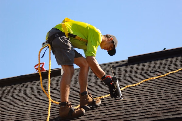Roofer working on residential roof